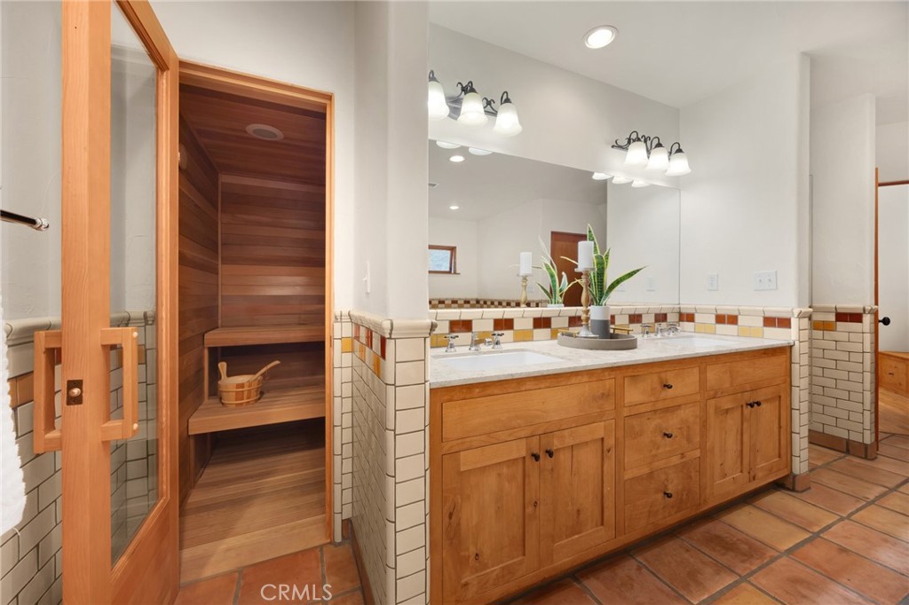 911 Laguna Road Fullerton, CA 92835 - Photo 51 of 68 a bathroom with a double vanity sink and a mirror