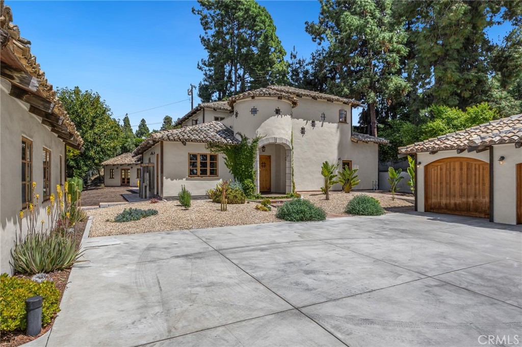911 Laguna Road Fullerton, CA 92835 - Photo 10 of 68 a view of a white house with a small yard and a large tree