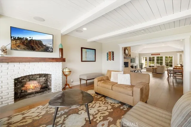 a living room with furniture a fireplace and a table