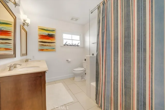 a bathroom with a toilet a sink and a mirror