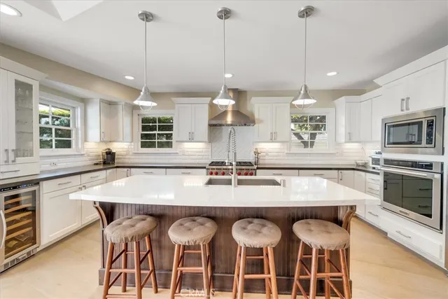 a large kitchen with a table and chairs