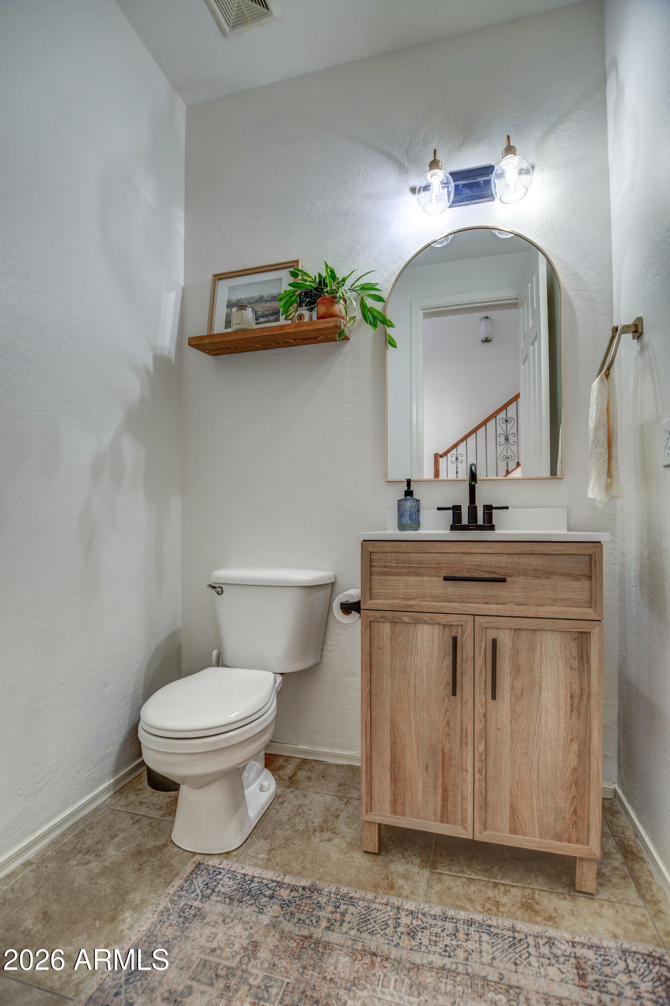 3078 East Muirfield Street Gilbert, AZ 85298 - Photo 24 of 92 a bathroom with a toilet a sink and mirror