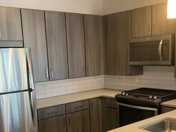 a kitchen with a refrigerator stove and cabinets