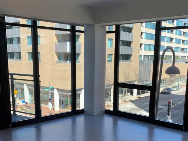 a view of a room with window and wooden floor