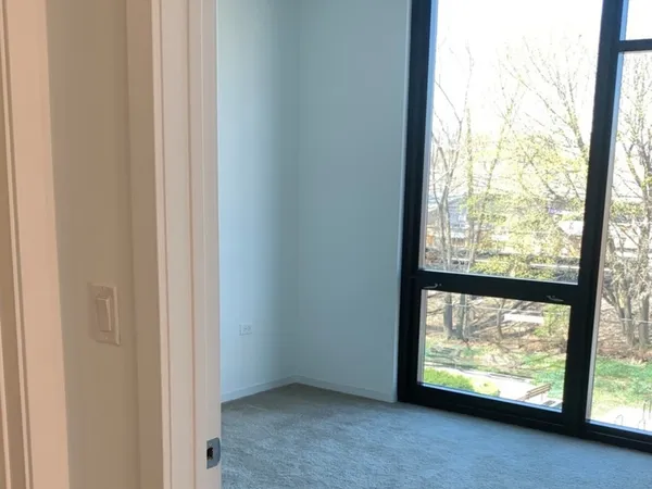 an empty room with large windows