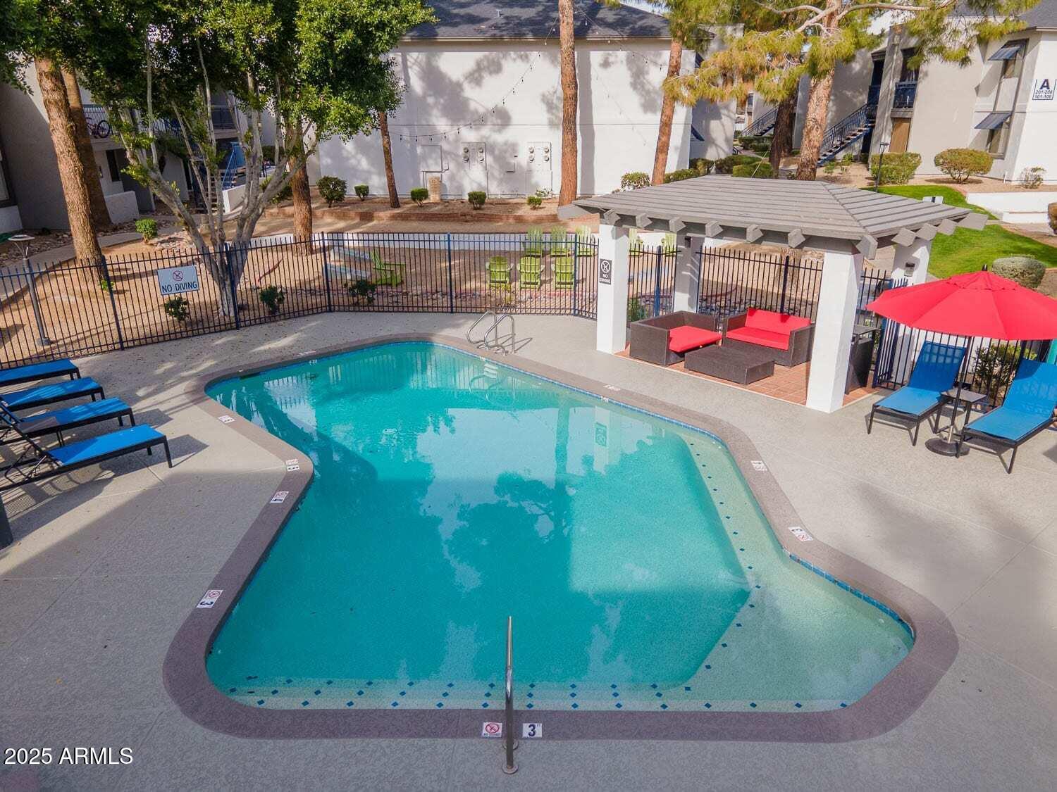 2311 East Union Hills Drive, Unit 22 Phoenix, AZ 85024 - Photo 9 of 12 a view of a swimming pool with a sitting area
