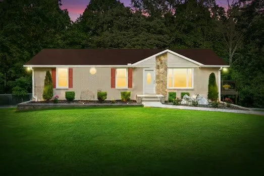 a front view of house with yard and green space