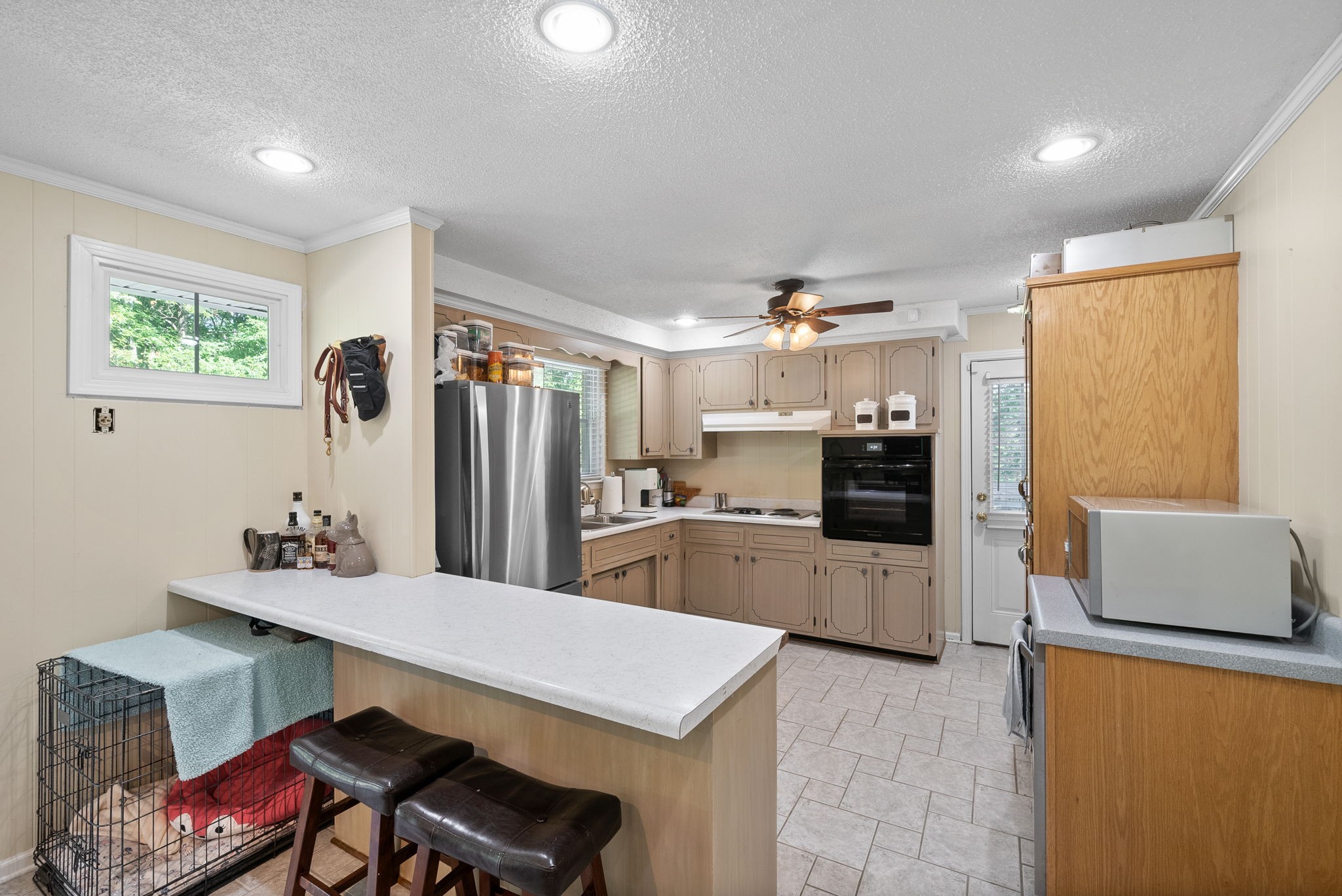 1001 Issac Clifton Road Chapmansboro, TN 37035 - Photo 12 of 47 a kitchen with stainless steel appliances kitchen island granite countertop a refrigerator and a stove top oven