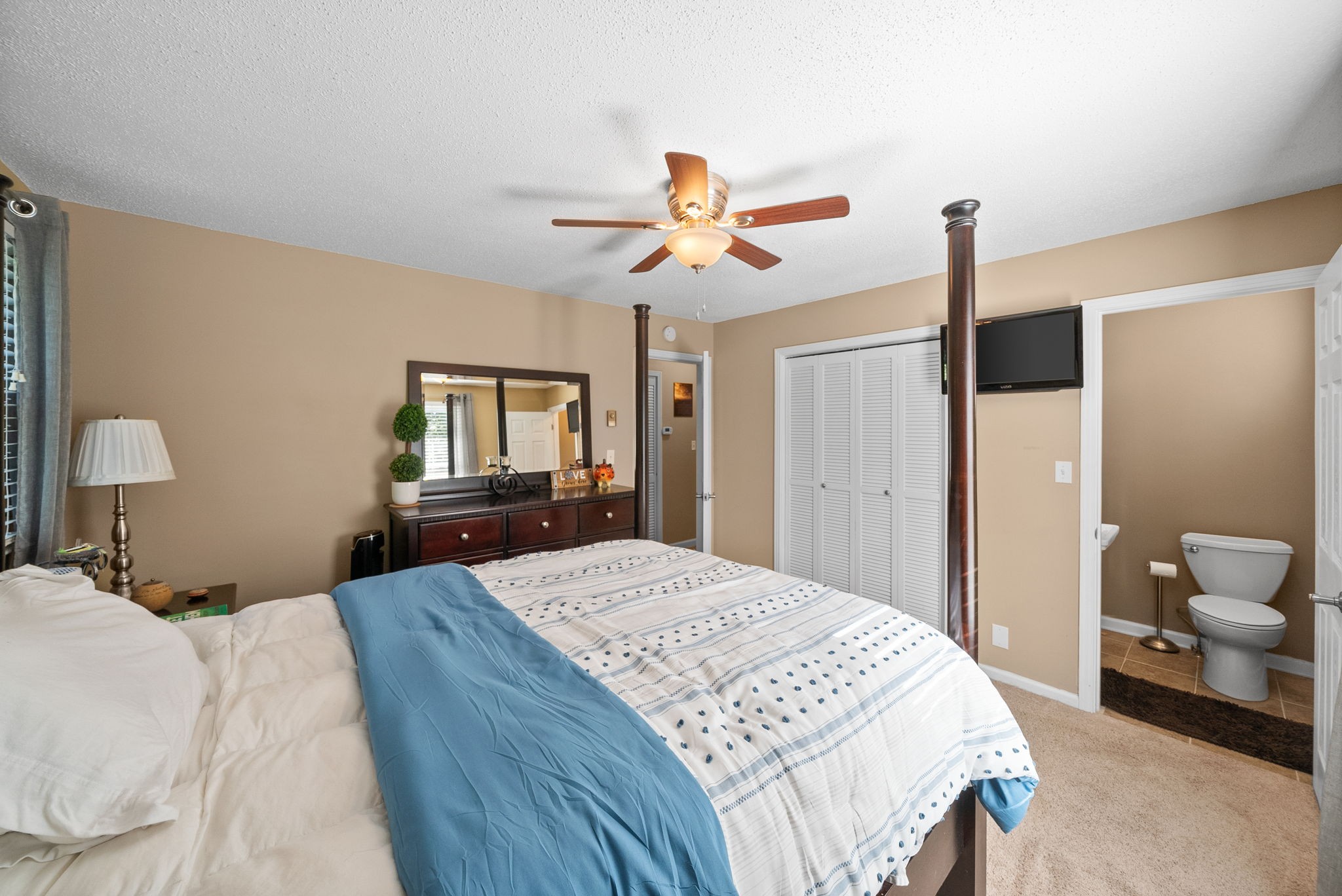 1001 Issac Clifton Road Chapmansboro, TN 37035 - Photo 17 of 47 a bedroom with a bed and a chandelier