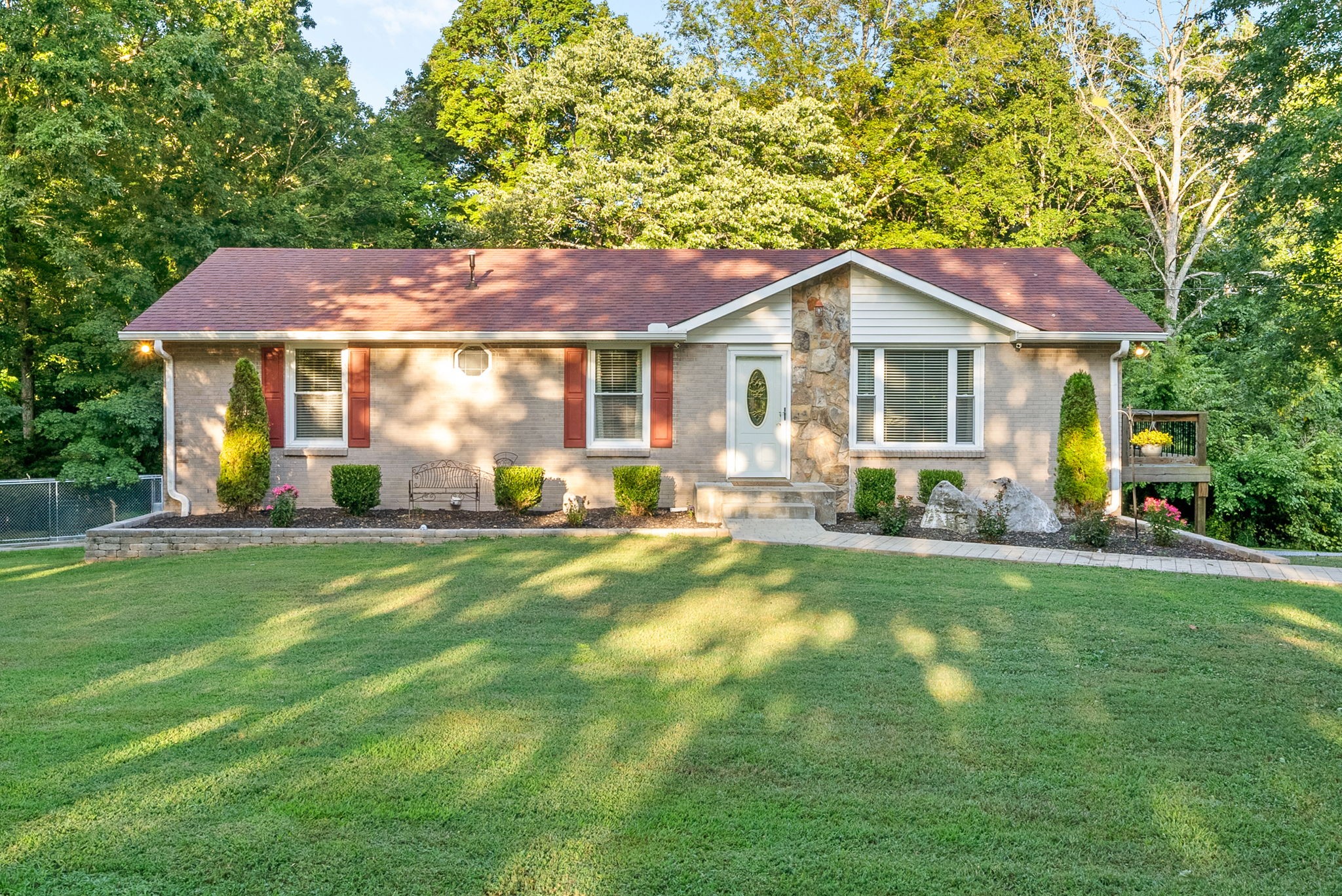 1001 Issac Clifton Road Chapmansboro, TN 37035 - Photo 2 of 47 a front view of a house with a yard and green space