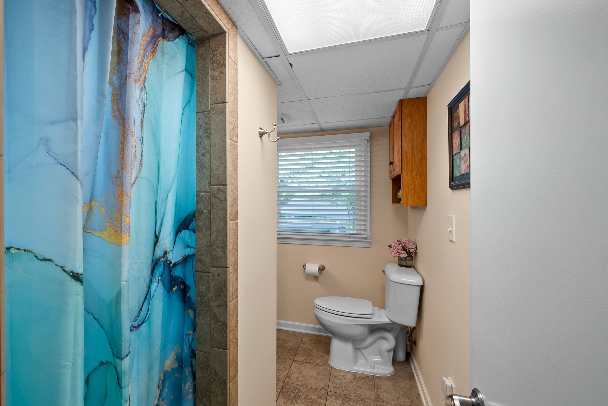 1001 Issac Clifton Road Chapmansboro, TN 37035 - Photo 37 of 47 a white toilet sitting next to a bathroom sink and vanity