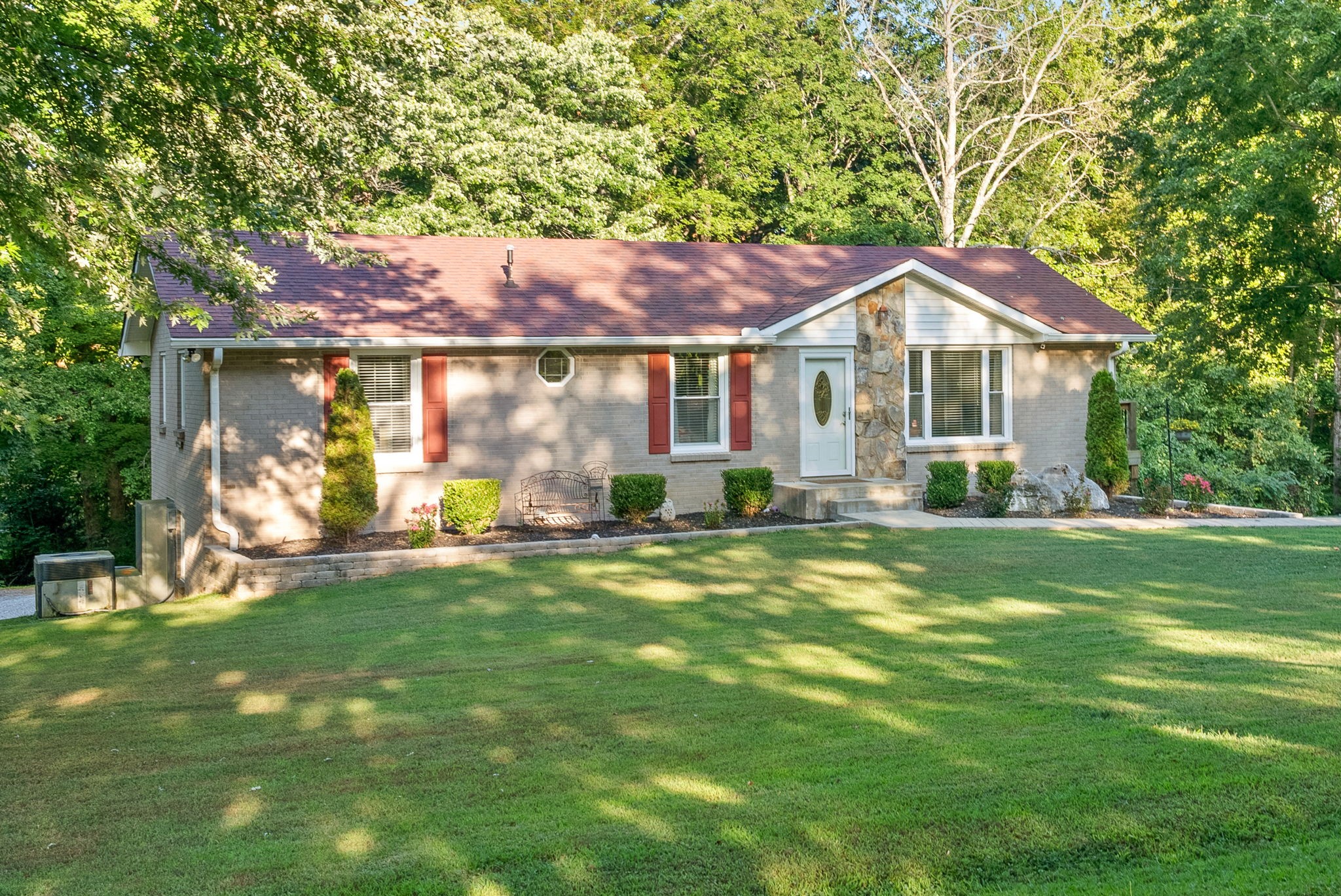 1001 Issac Clifton Road Chapmansboro, TN 37035 - Photo 4 of 47 a front view of a house with a garden