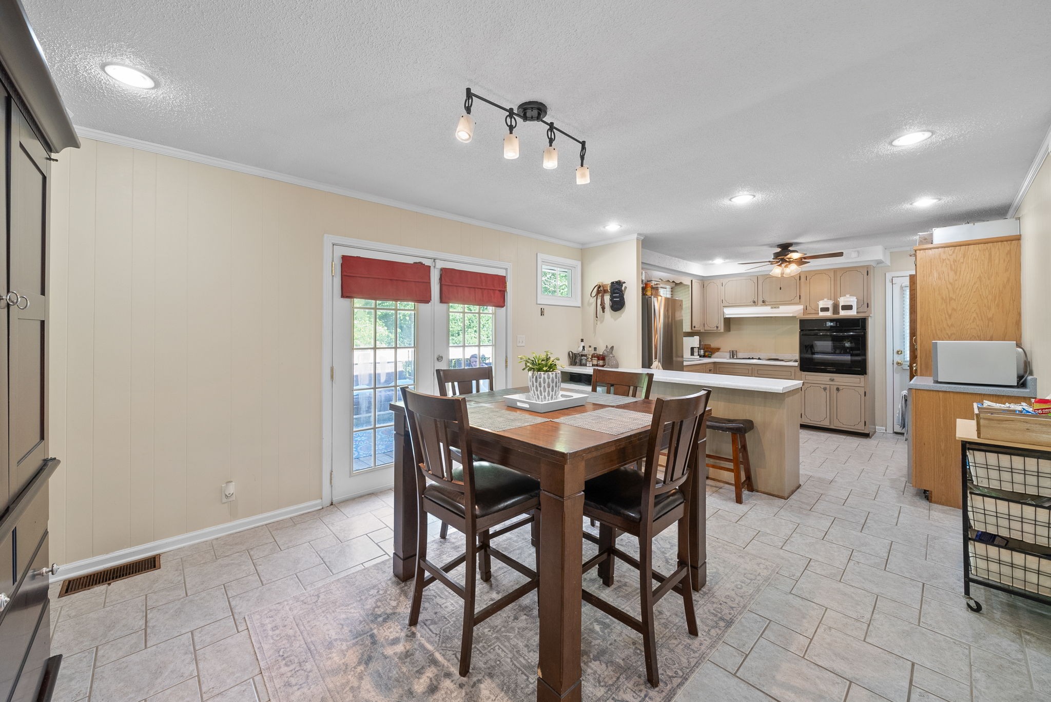1001 Issac Clifton Road Chapmansboro, TN 37035 - Photo 10 of 47 a kitchen with a dining table chairs stainless steel appliances and cabinets