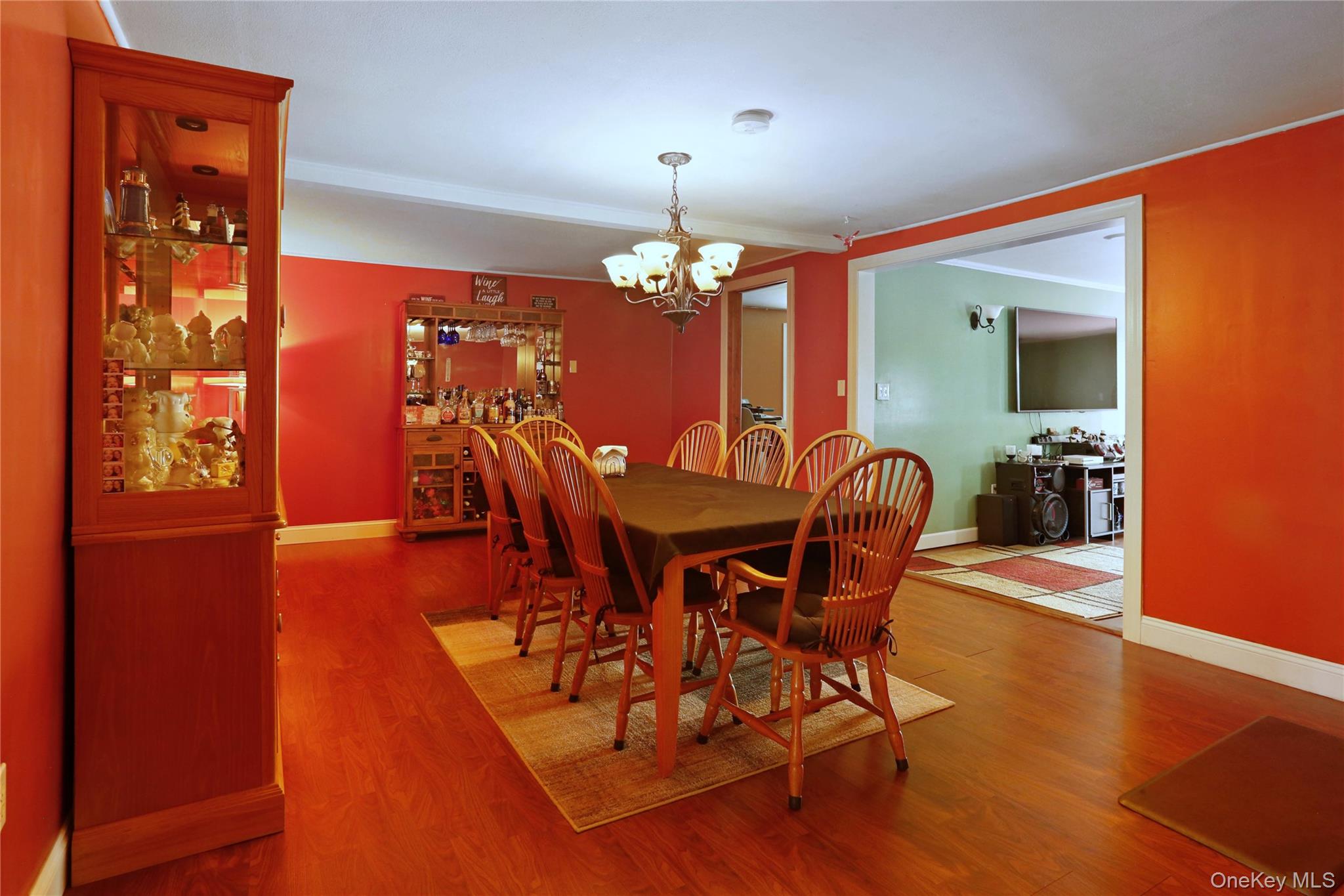 650 Granite Road Kerhonkson, NY 12446 - Photo 16 of 38 a dining room with furniture a chandelier and wooden floor