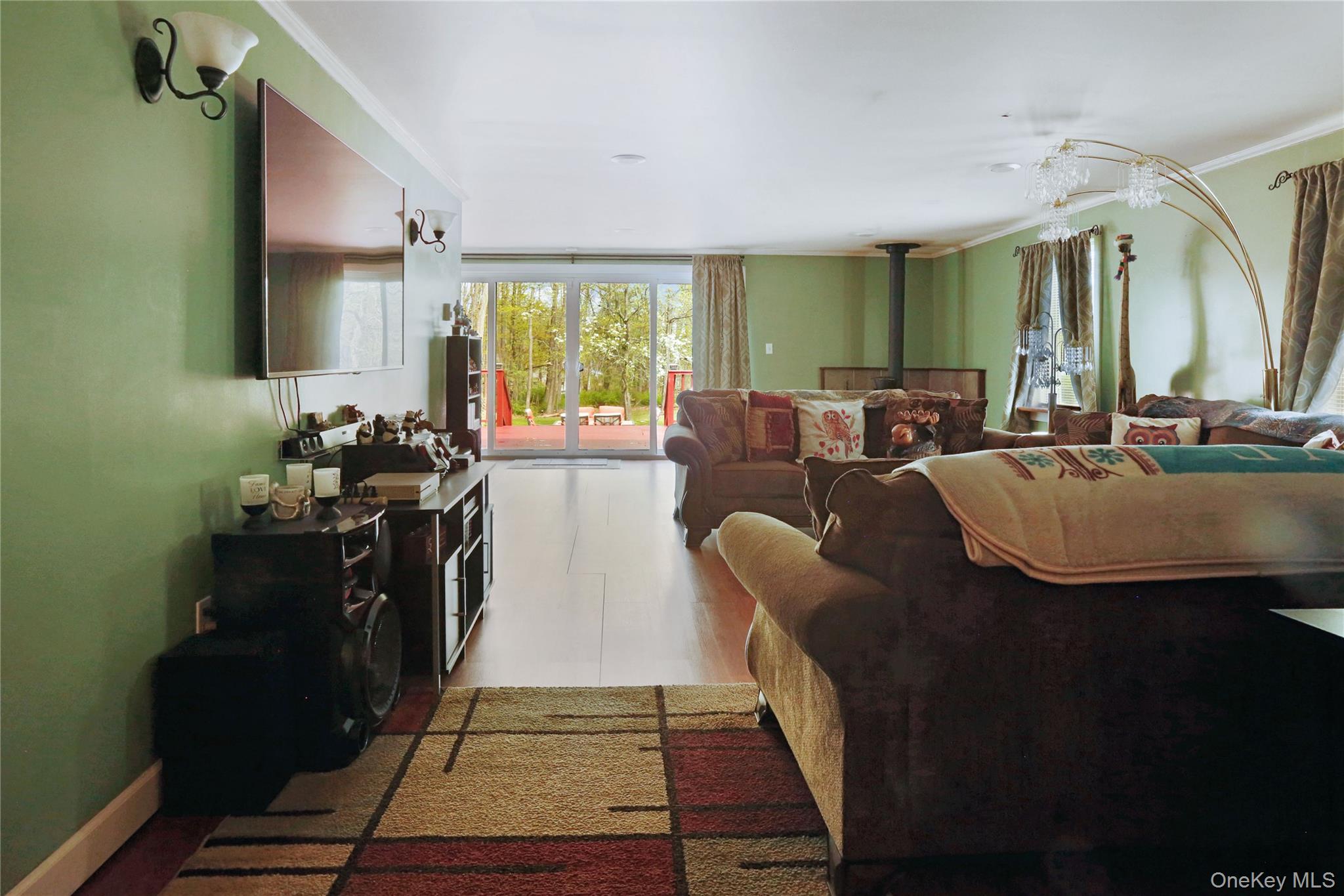 650 Granite Road Kerhonkson, NY 12446 - Photo 17 of 38 a living room with furniture a large window and potted plants