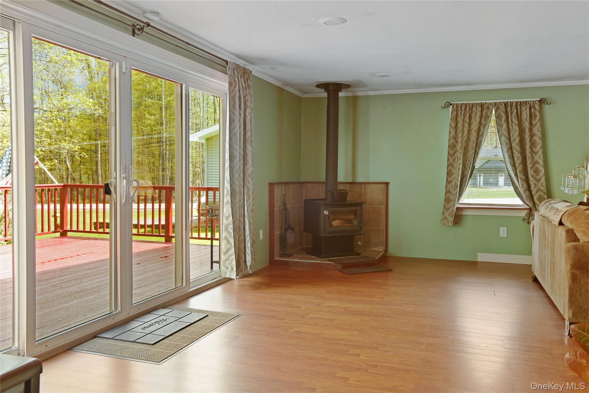 650 Granite Road Kerhonkson, NY 12446 - Photo 21 of 38 a living room with hardwood floor and a balcony