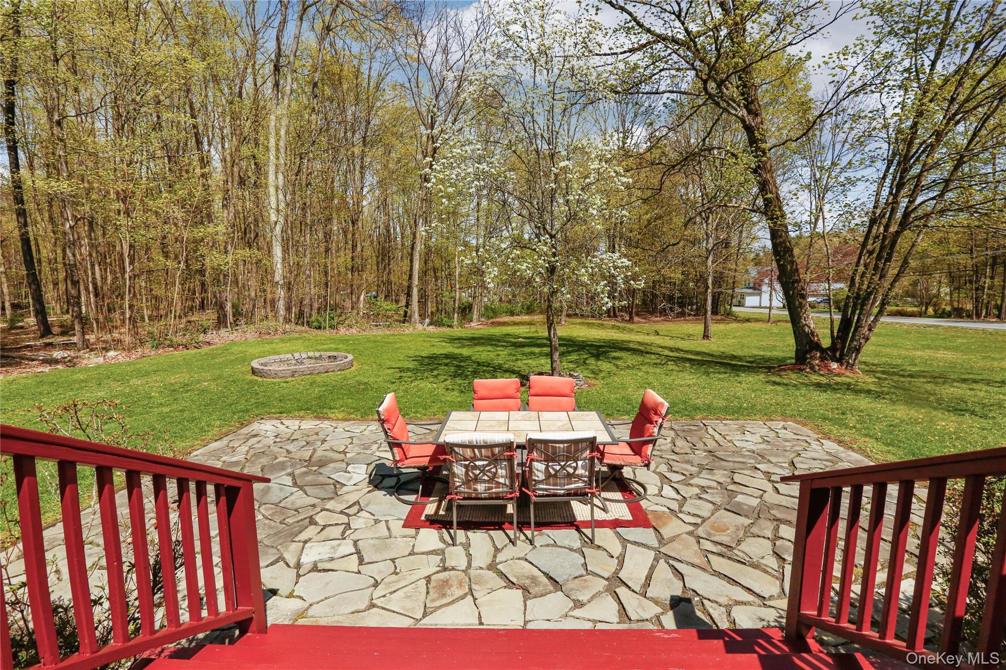 650 Granite Road Kerhonkson, NY 12446 - Photo 23 of 38 a view of a table and chairs with backyard and wooden fence