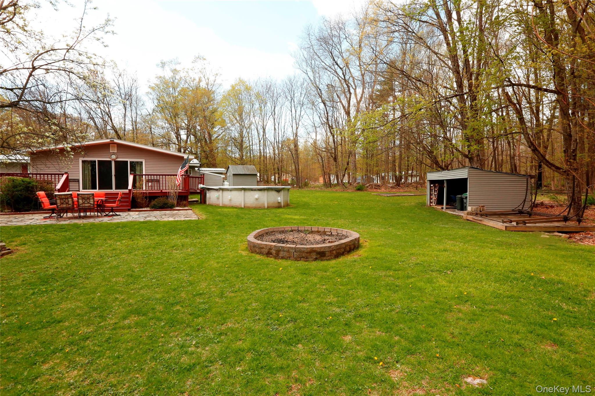 650 Granite Road Kerhonkson, NY 12446 - Photo 26 of 38 a view of a house with a big yard and sitting area