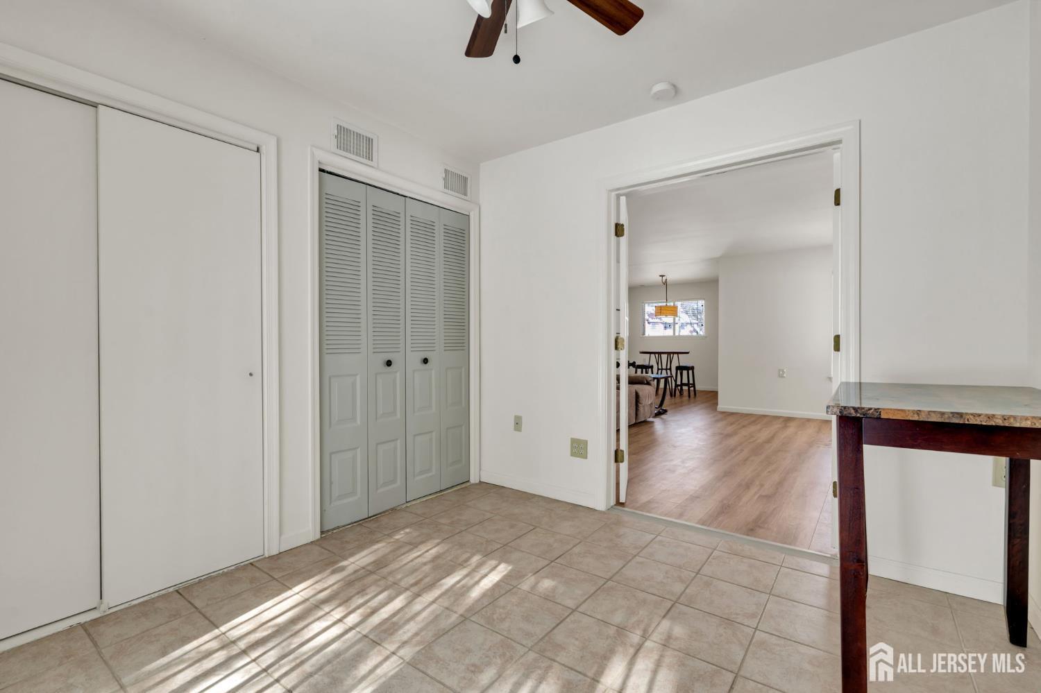 603 Jacob Court Dayton, NJ 08810 - Photo 13 of 18 a view of a hallway view with wooden floor and a chandelier fan