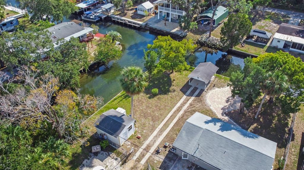 Teal Drive Weeki Wachee, FL 34607 - Photo 17 of 18 an aerial view of a house with a garden and lake view