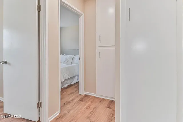 a large bed sitting in a bedroom next to a window