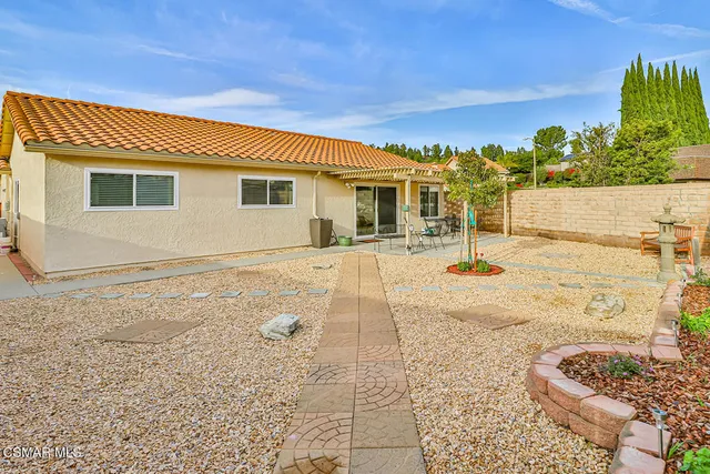 a swimming pool with barbeque oven in front of it