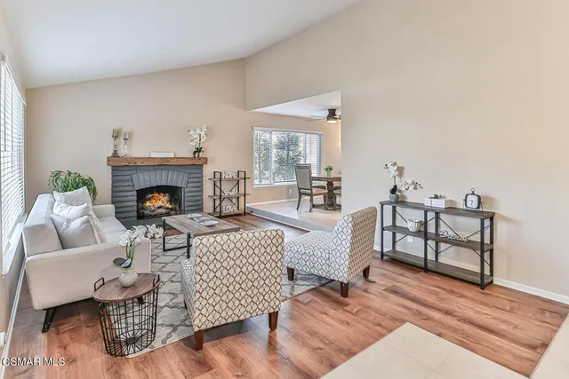 a living room with furniture a fireplace and a table