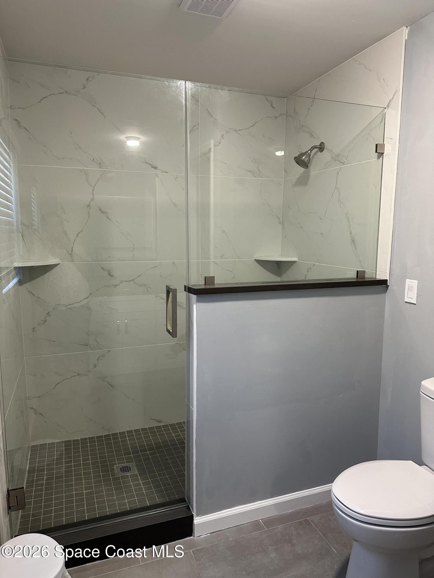 3600 Aurora Road, Unit A Melbourne, FL 32934 - Photo 3 of 6 a bathroom with a toilet and a shower