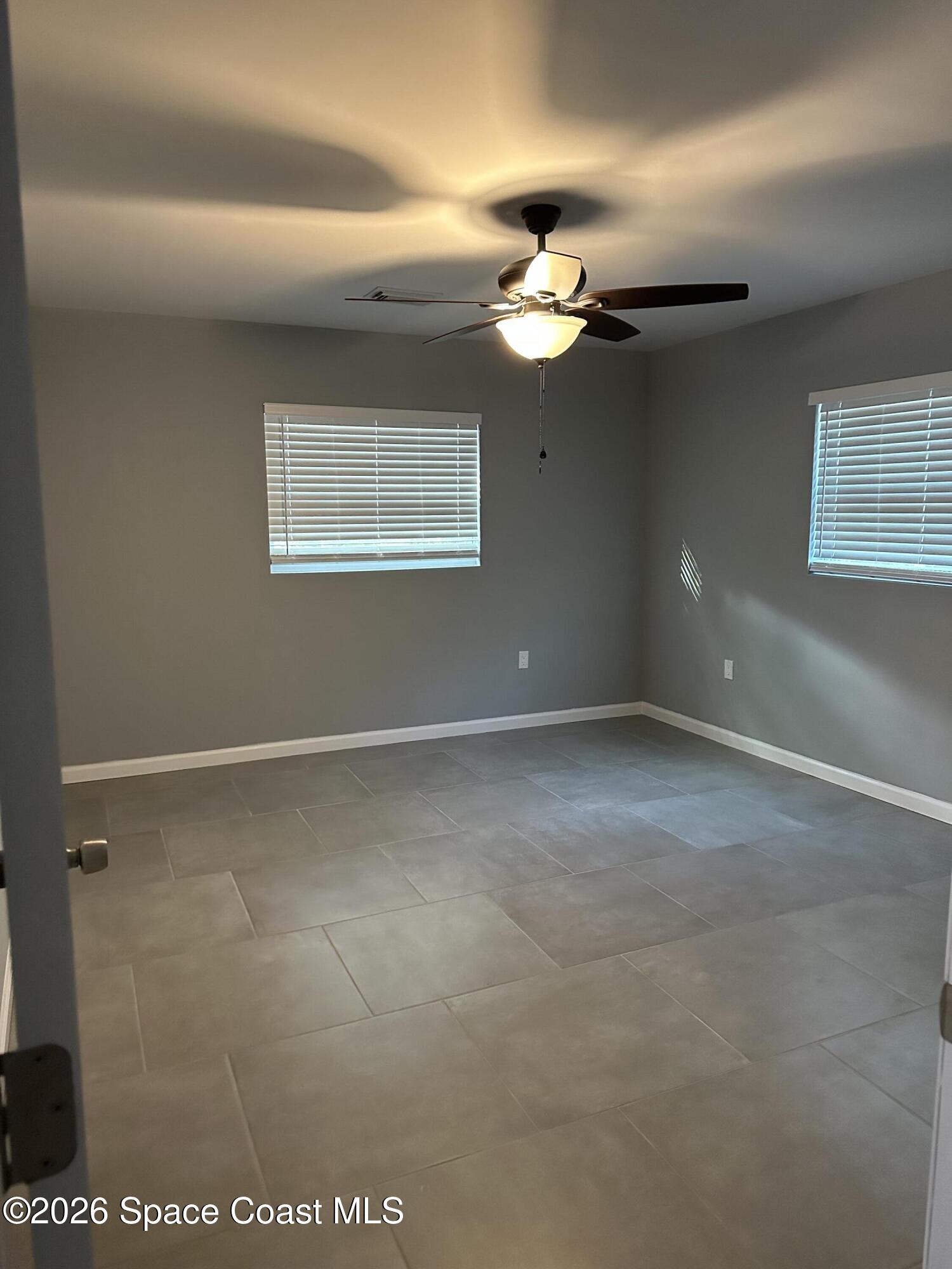 3600 Aurora Road, Unit A Melbourne, FL 32934 - Photo 5 of 6 a view of an empty room with a window
