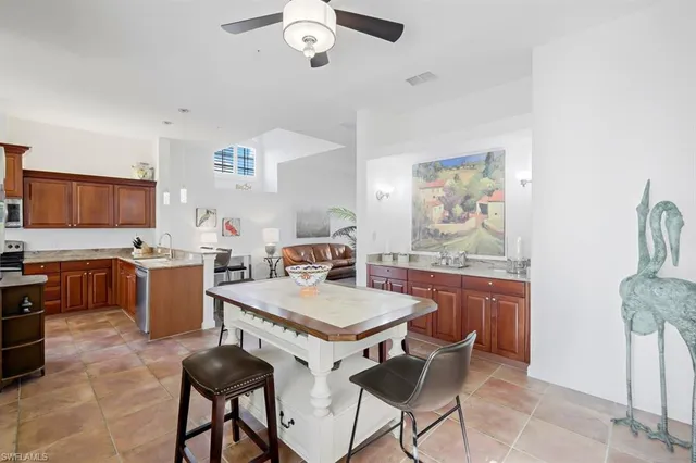 a kitchen with a table chairs sink and cabinets