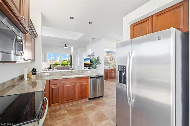 a kitchen with stainless steel appliances a refrigerator sink and cabinets