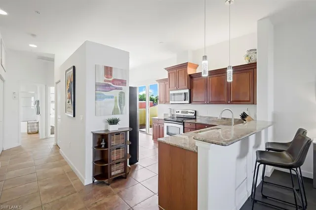 a kitchen with cabinets and chairs