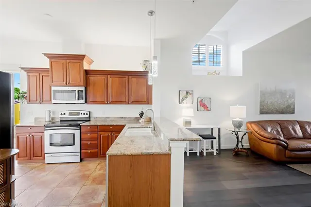 a living room with furniture and kitchen