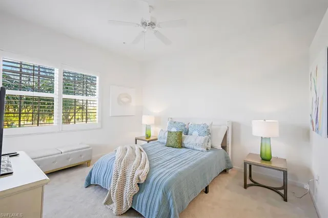 a bedroom with a bed lamps and window