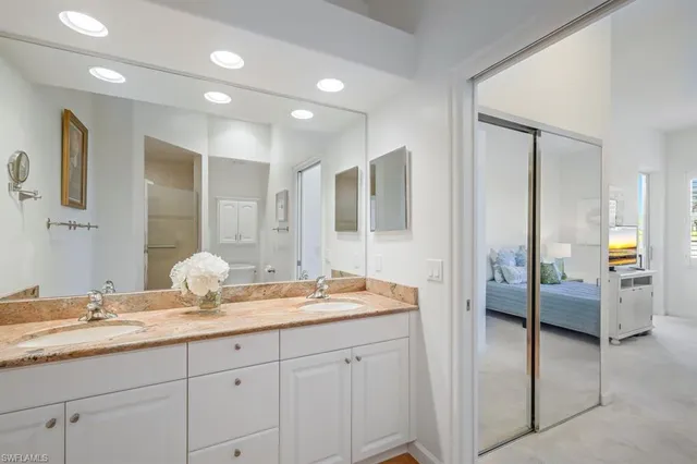 a en suite bathroom with double sink and a mirror