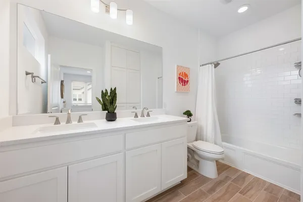 a view of a kitchen with white cabinets