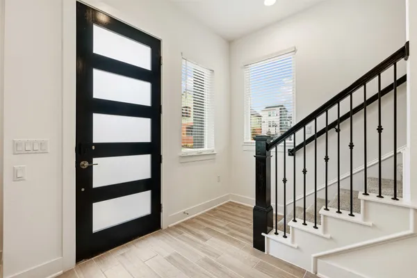 a view of staircase with white walls and a window