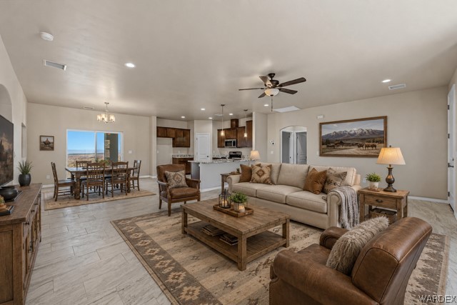 9818 North Cyrus Road Kingman, AZ 86401 - Photo 6 of 42 a living room with furniture ceiling fan and a rug