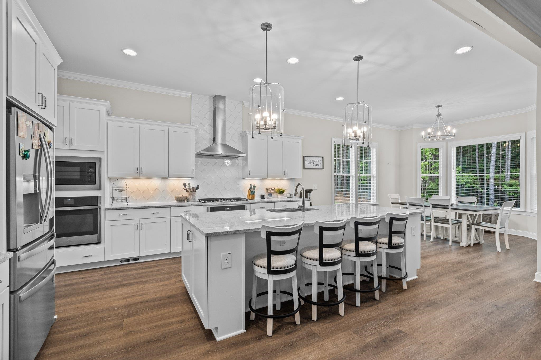 116 Brandy Mill Pittsboro, NC 27312 - Photo 13 of 47 a large kitchen with kitchen island granite countertop lots of white cabinets appliances and dining table
