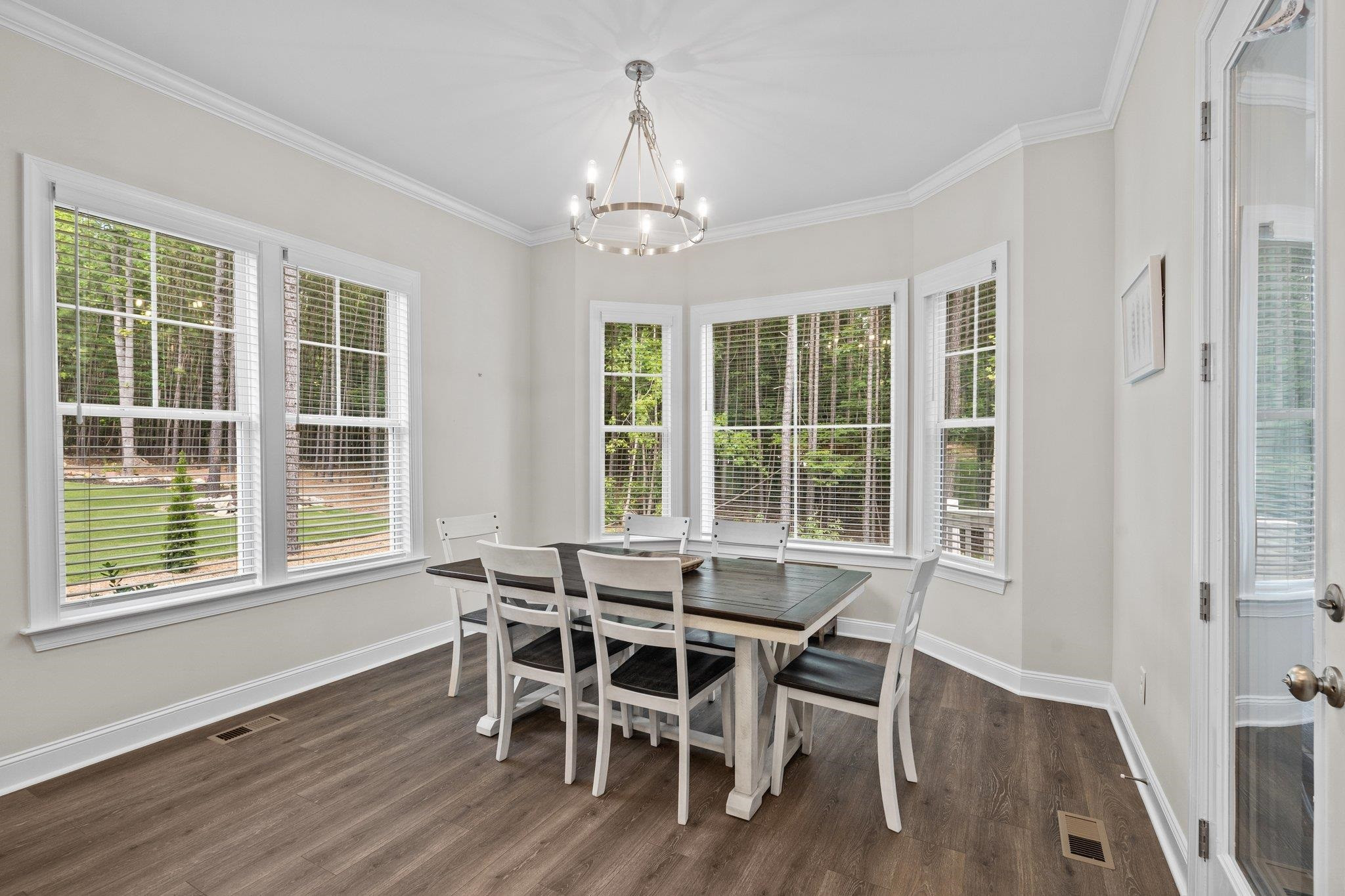 116 Brandy Mill Pittsboro, NC 27312 - Photo 19 of 47 a dining room with wooden floor a chandelier a glass table and chairs