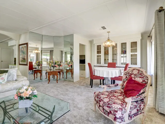 a living room with furniture and dining table