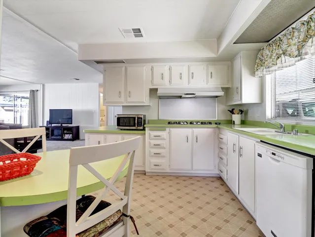 a view of a dining room with furniture and a chandelier