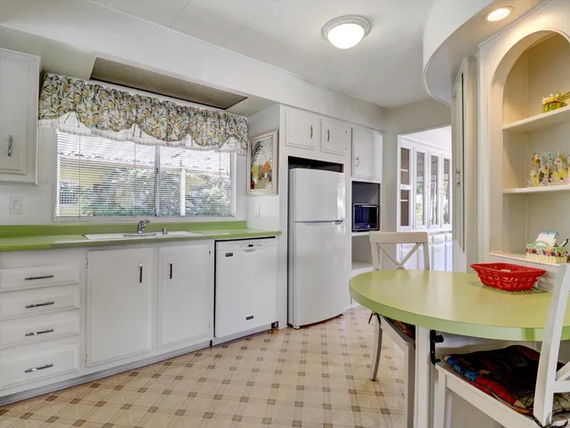a kitchen with white cabinets