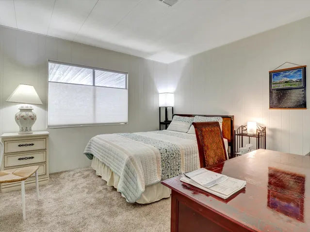 a bedroom with a bed and a mirror