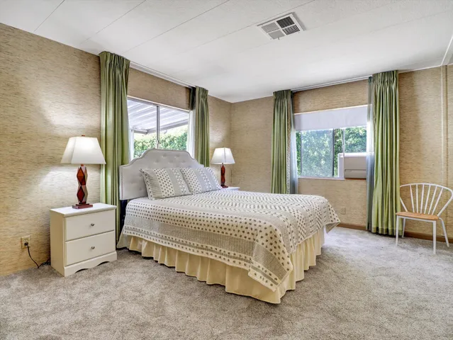 a bedroom with a large bed and a lamp