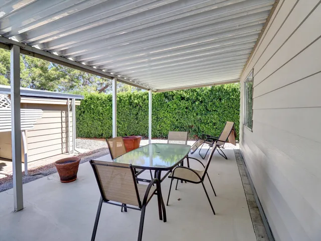 a balcony with table and chairs
