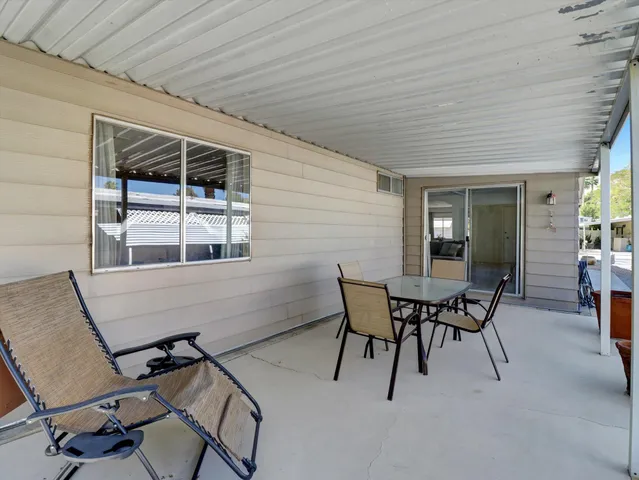 a view of a porch with wooden floor