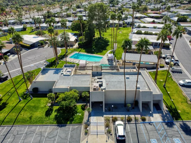 an aerial view of a house with a garden and patio
