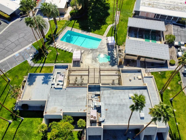 an aerial view of a house with a garden and patio