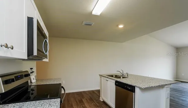 a kitchen with a sink and a stove